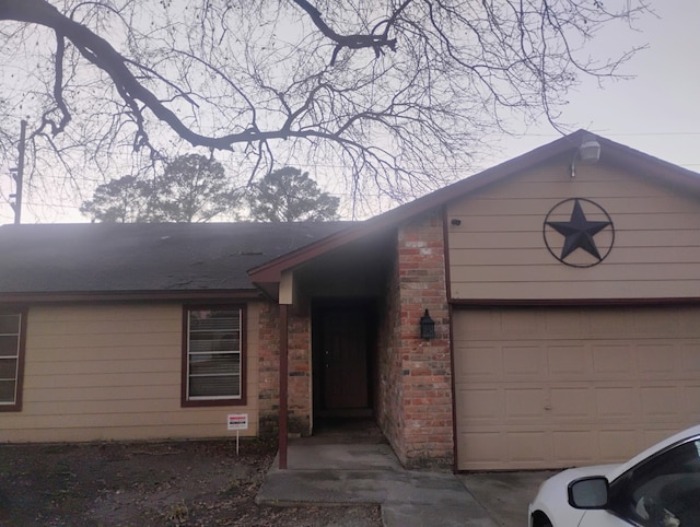 view of front of home featuring brick siding and an attached garage