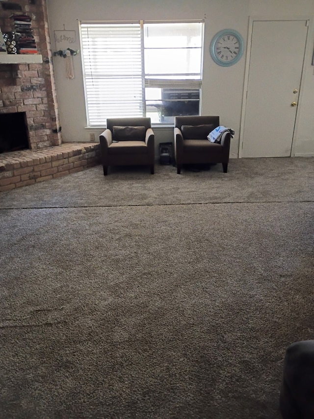 carpeted living room with a brick fireplace