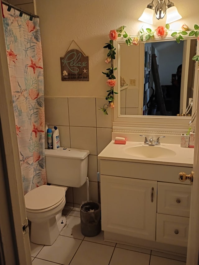 full bath featuring vanity, tile patterned flooring, curtained shower, tile walls, and toilet