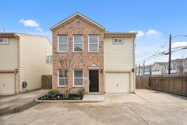 view of front of home with brick siding, concrete driveway, and fence