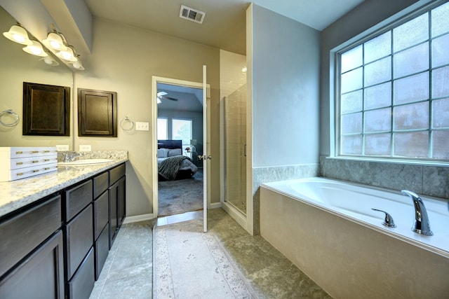 ensuite bathroom featuring vanity, baseboards, visible vents, a bath, and connected bathroom