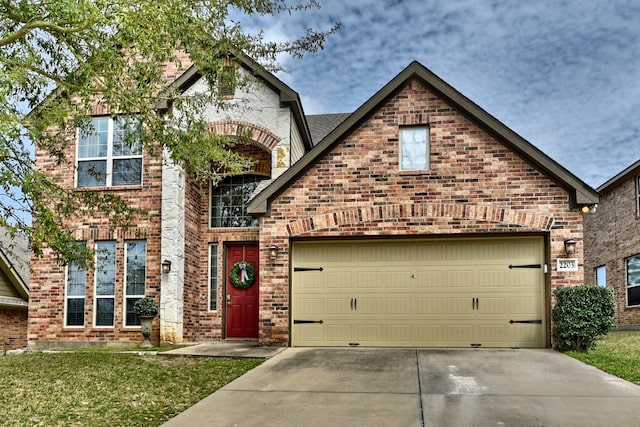 view of front facade featuring brick siding, an attached garage, concrete driveway, and a front lawn