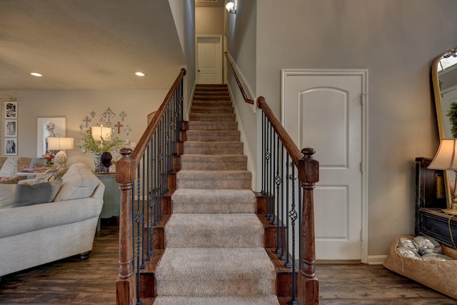 staircase featuring recessed lighting and wood finished floors