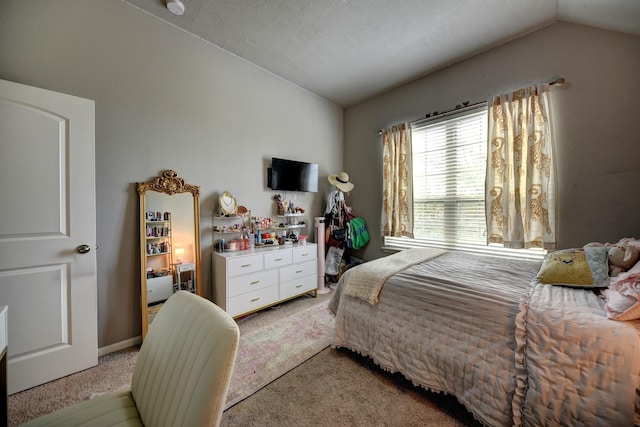 bedroom with vaulted ceiling and light carpet