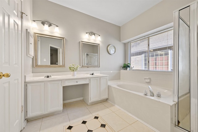 full bathroom with tile patterned floors, a garden tub, double vanity, and a stall shower