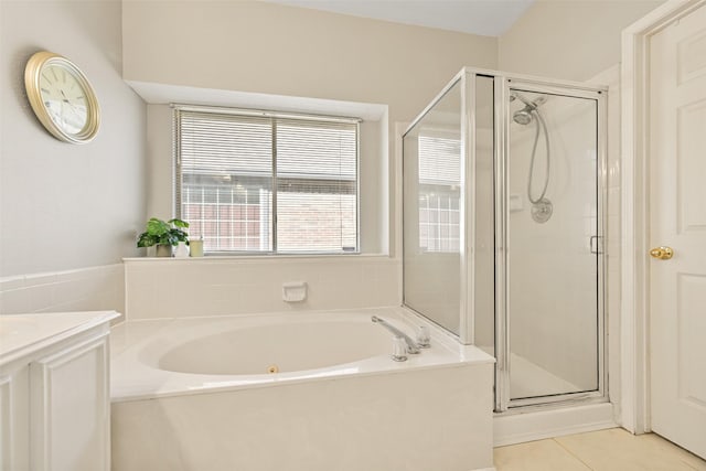 full bathroom with tile patterned flooring, a stall shower, vanity, and a garden tub