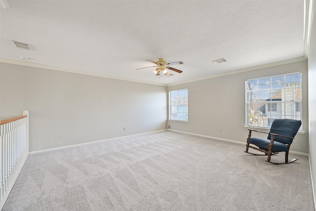 unfurnished room featuring baseboards, visible vents, carpet floors, ornamental molding, and a textured ceiling