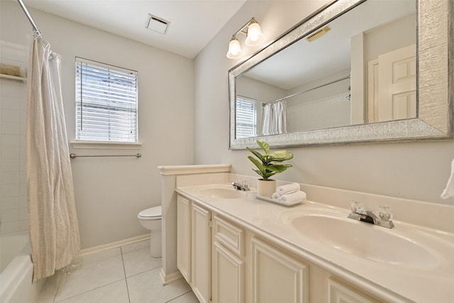 bathroom with tile patterned floors, toilet, visible vents, and a sink