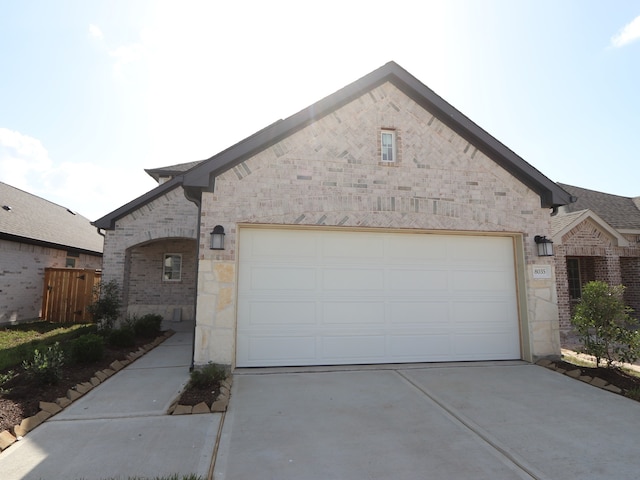8035 Kay Harbor Dr, Cypress, TX 77433 - french country inspired facade with concrete driveway, stone siding, an attached garage, and brick siding