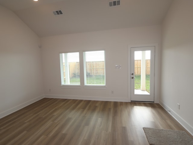 8035 Kay Harbor Dr, Cypress, TX 77433 - empty room with plenty of natural light, wood finished floors, and vaulted ceiling