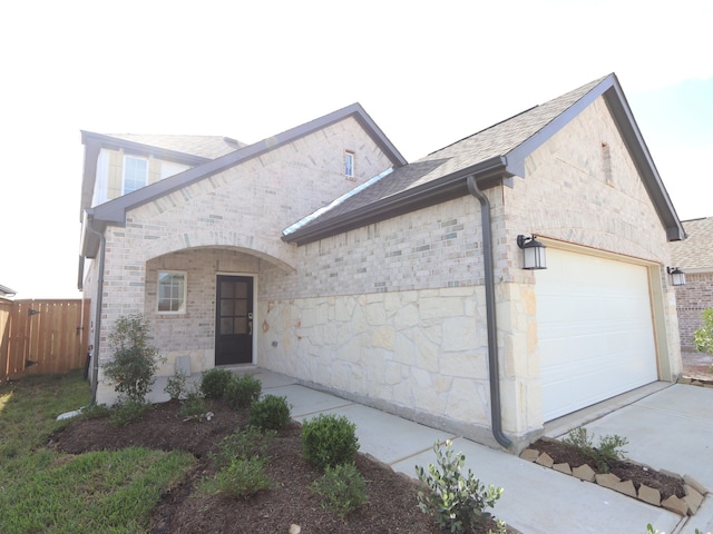 8035 Kay Harbor Dr, Cypress, TX 77433 - view of front of property featuring a garage, stone siding, driveway, and roof with shingles
