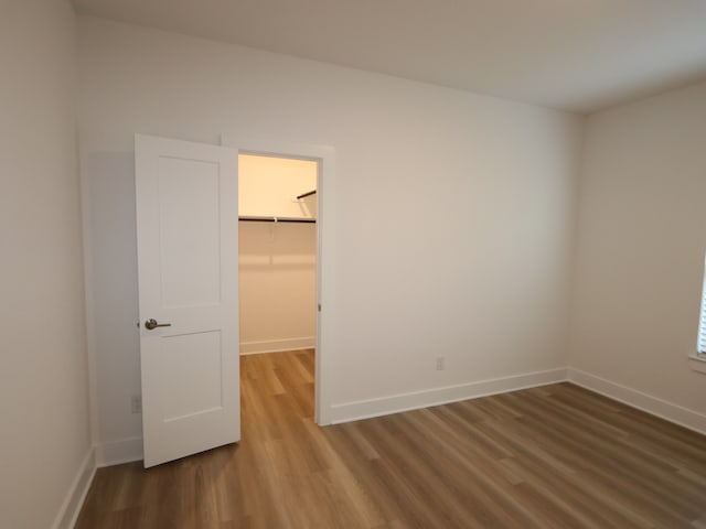 8035 Kay Harbor Dr, Cypress, TX 77433 - unfurnished bedroom with wood finished floors, a walk in closet, and a closet