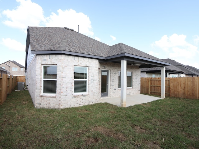 8035 Kay Harbor Dr, Cypress, TX 77433 - rear view of property with a shingled roof, a patio area, a ceiling fan, a fenced backyard, and brick siding