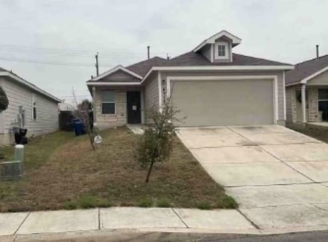 view of front of home with concrete driveway and an attached garage