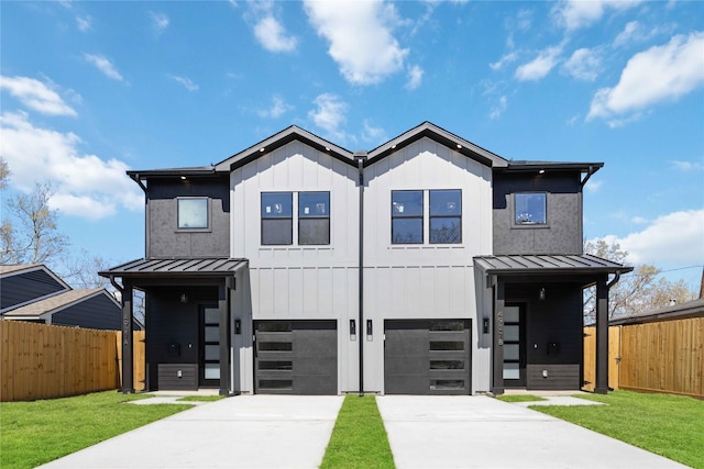 view of front facade with an attached garage, a standing seam roof, and fence