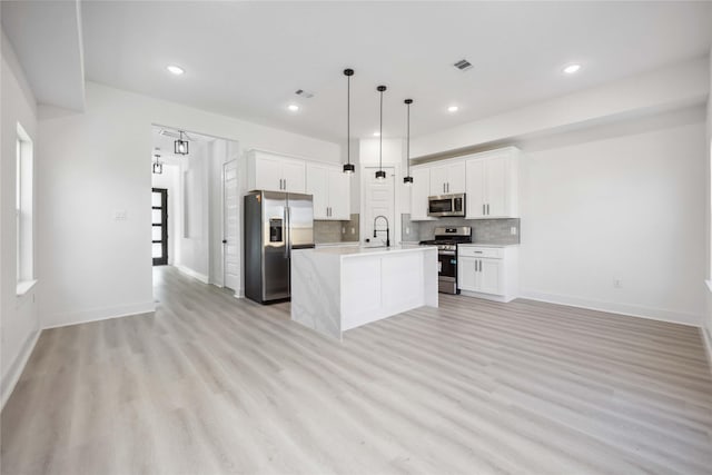 kitchen with decorative backsplash, stainless steel appliances, light countertops, and a sink