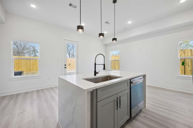 kitchen featuring visible vents, gray cabinetry, recessed lighting, stainless steel dishwasher, and a sink