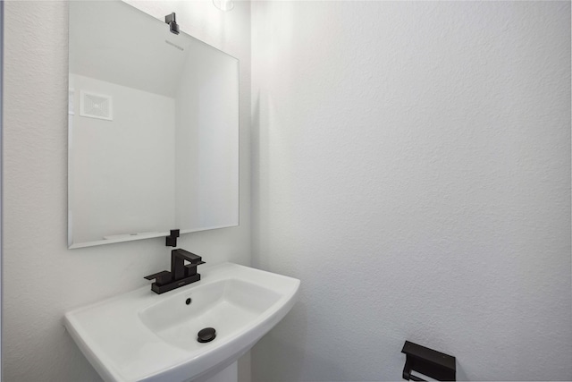 bathroom featuring visible vents and a sink