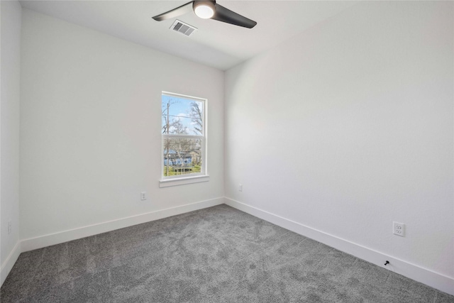 carpeted empty room featuring a ceiling fan, baseboards, and visible vents