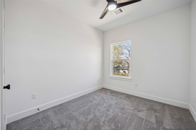 spare room featuring a ceiling fan, baseboards, visible vents, and carpet floors