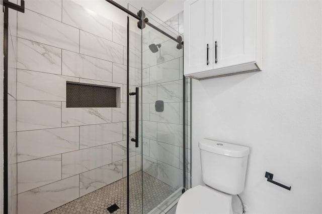 full bathroom with a shower stall and toilet