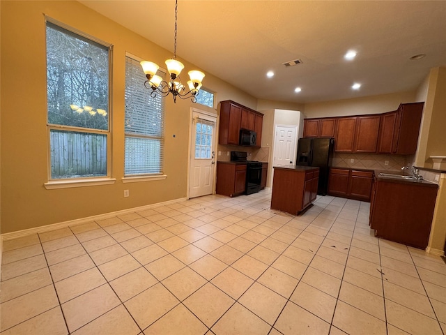 kitchen with a sink, decorative backsplash, black appliances, dark countertops, and a center island