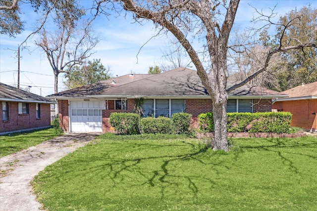 single story home featuring a front lawn, an attached garage, brick siding, and concrete driveway