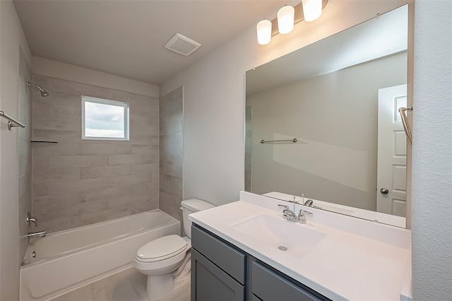 bathroom featuring visible vents, toilet, vanity, and shower / tub combination