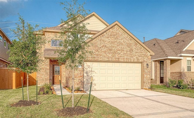 view of front facade featuring driveway, fence, a front yard, an attached garage, and brick siding