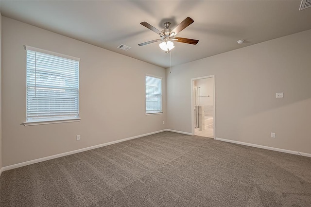 unfurnished room with ceiling fan, carpet, visible vents, and baseboards