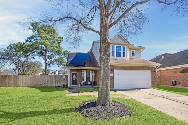 traditional home with driveway, fence, a front yard, a garage, and solar panels