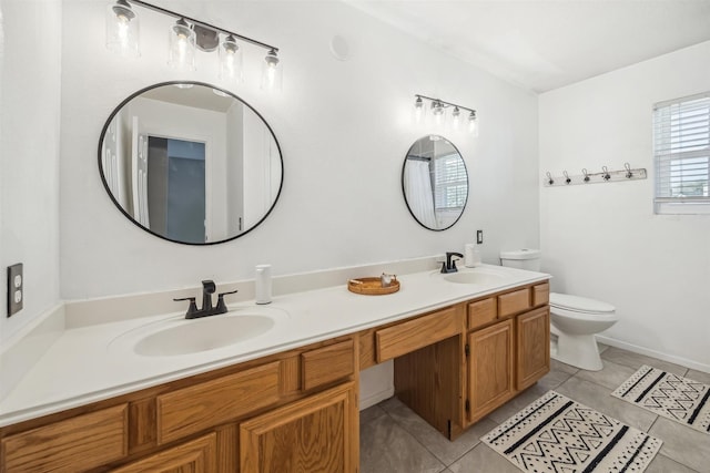 full bath featuring a sink, toilet, double vanity, and tile patterned flooring