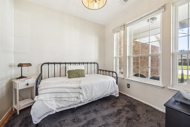 carpeted bedroom featuring visible vents and baseboards