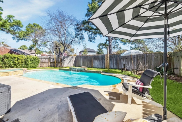 view of pool with a patio area, a pool with connected hot tub, and a fenced backyard