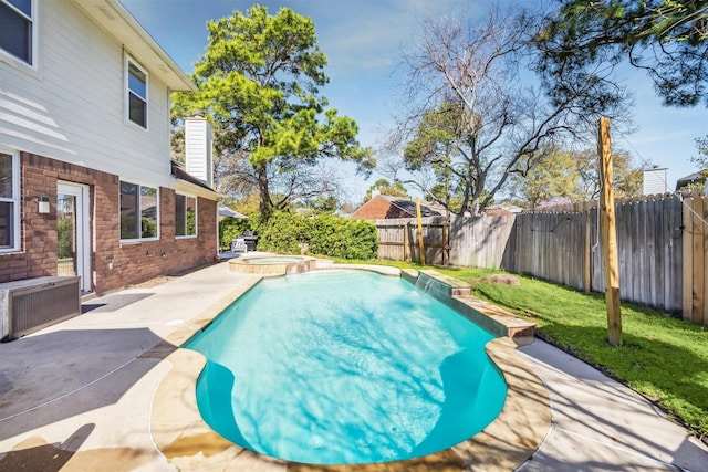 view of pool featuring a patio, a lawn, a fenced backyard, and a pool with connected hot tub