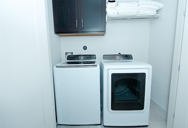 clothes washing area with cabinet space and washing machine and clothes dryer