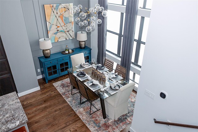 dining area with baseboards and wood finished floors