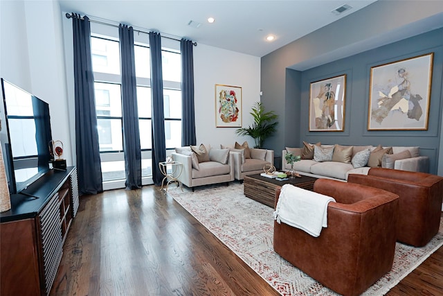 living room featuring recessed lighting, visible vents, and dark wood-type flooring