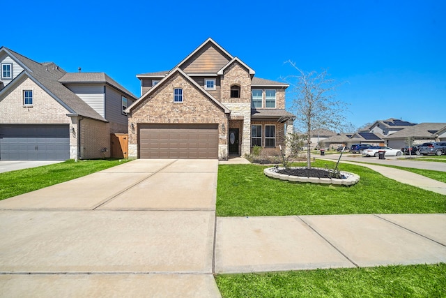 view of front facade with a front yard, brick siding, and driveway