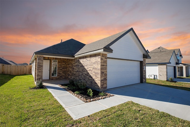 ranch-style house featuring fence, concrete driveway, a garage, a lawn, and brick siding