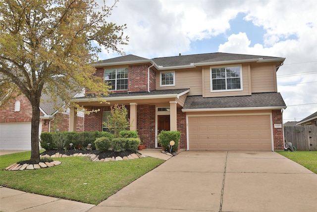 view of front facade featuring a front yard, fence, concrete driveway, a garage, and brick siding