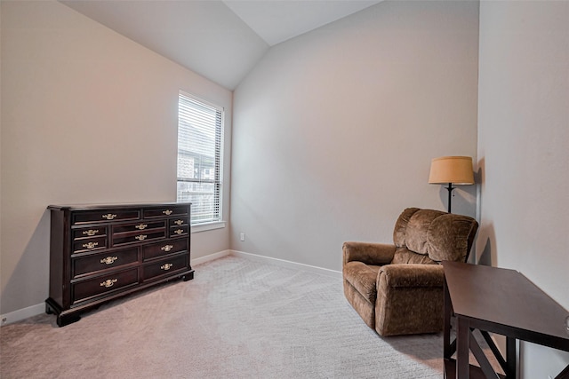 living area with light carpet, baseboards, and vaulted ceiling