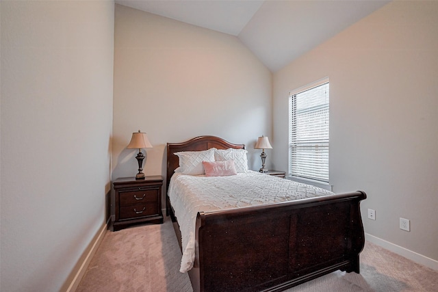 bedroom with baseboards, lofted ceiling, and light colored carpet