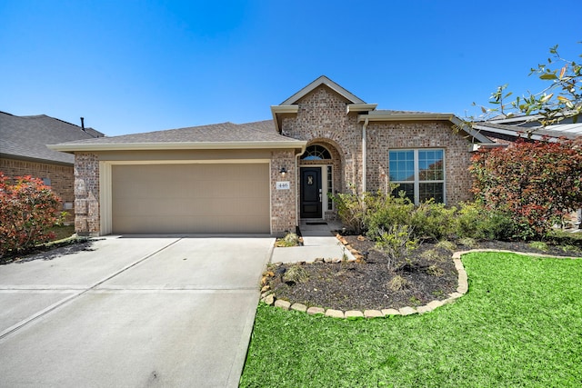 view of front of property with a front lawn, a garage, brick siding, and driveway