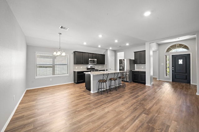 kitchen with plenty of natural light, tasteful backsplash, appliances with stainless steel finishes, and a chandelier