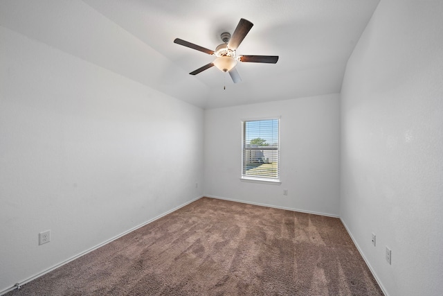 carpeted empty room with lofted ceiling, baseboards, and ceiling fan