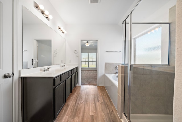 full bathroom with visible vents, a garden tub, wood finished floors, and a shower stall