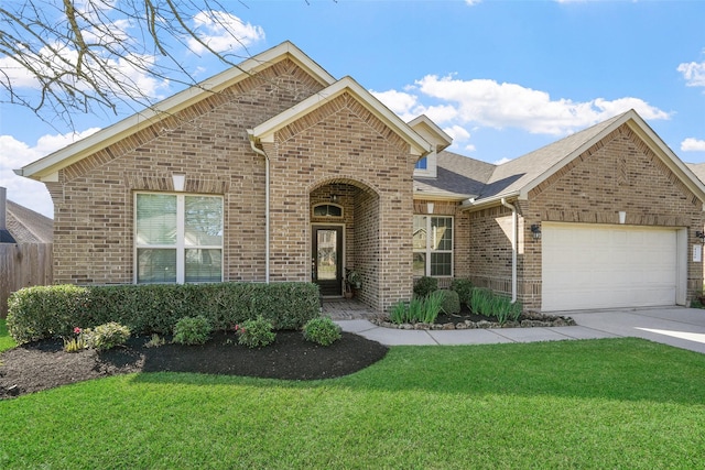 traditional-style home featuring brick siding, a shingled roof, a front yard, driveway, and an attached garage