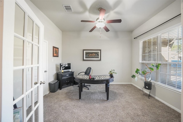 carpeted office space with visible vents, ceiling fan, french doors, and baseboards