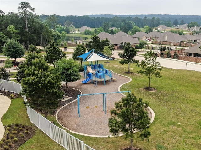 communal playground with a lawn and fence